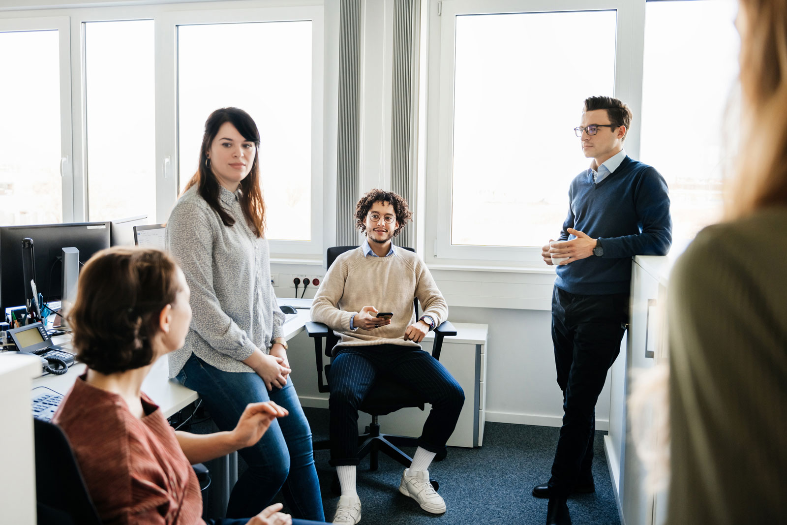 A team of employees listening attentively during an empathetic management discussion.